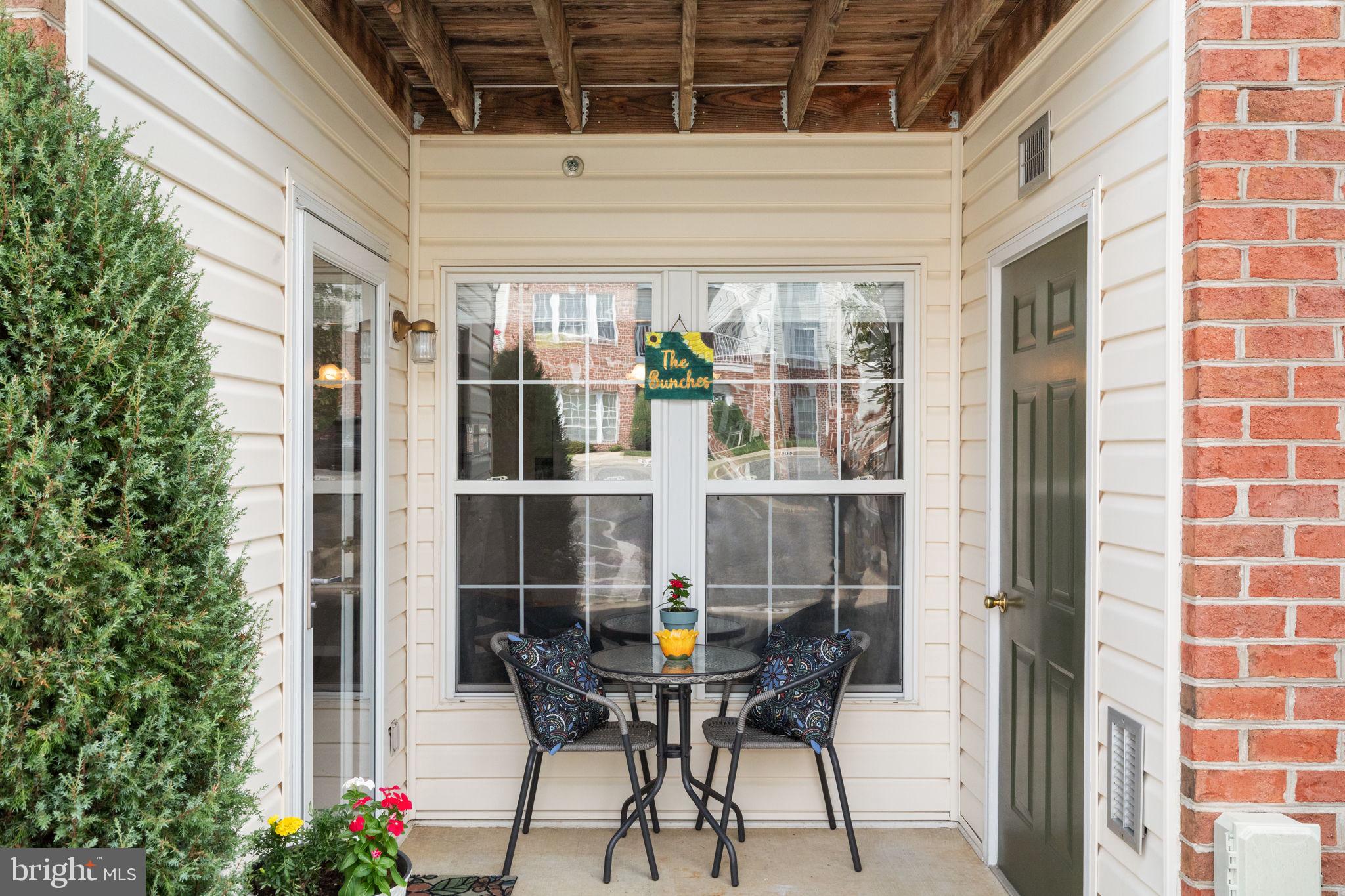 16 Brook Farm Court, Unit 16D Perry Hall, MD 21128 - Photo 21 of 23 a table and chairs in front of a door