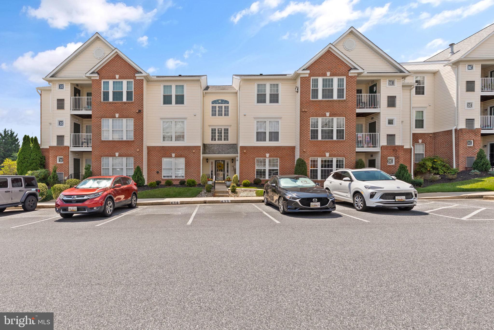 16 Brook Farm Court, Unit 16D Perry Hall, MD 21128 - Photo 23 of 23 a car parked in front of a white house