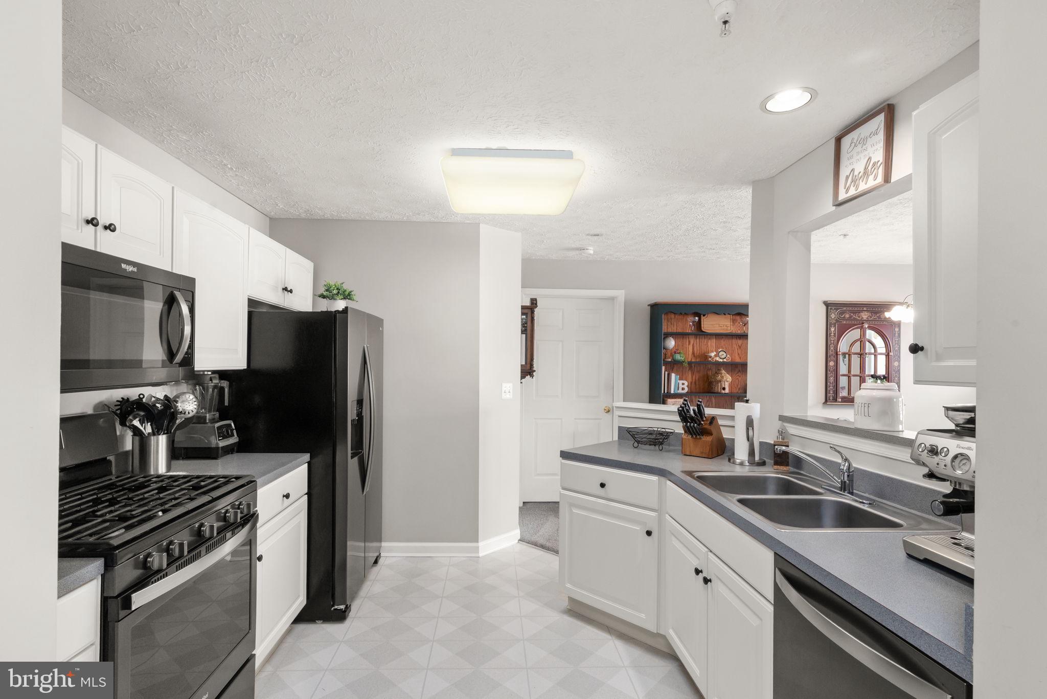 16 Brook Farm Court, Unit 16D Perry Hall, MD 21128 - Photo 3 of 23 a kitchen with stainless steel appliances a sink stove and refrigerator