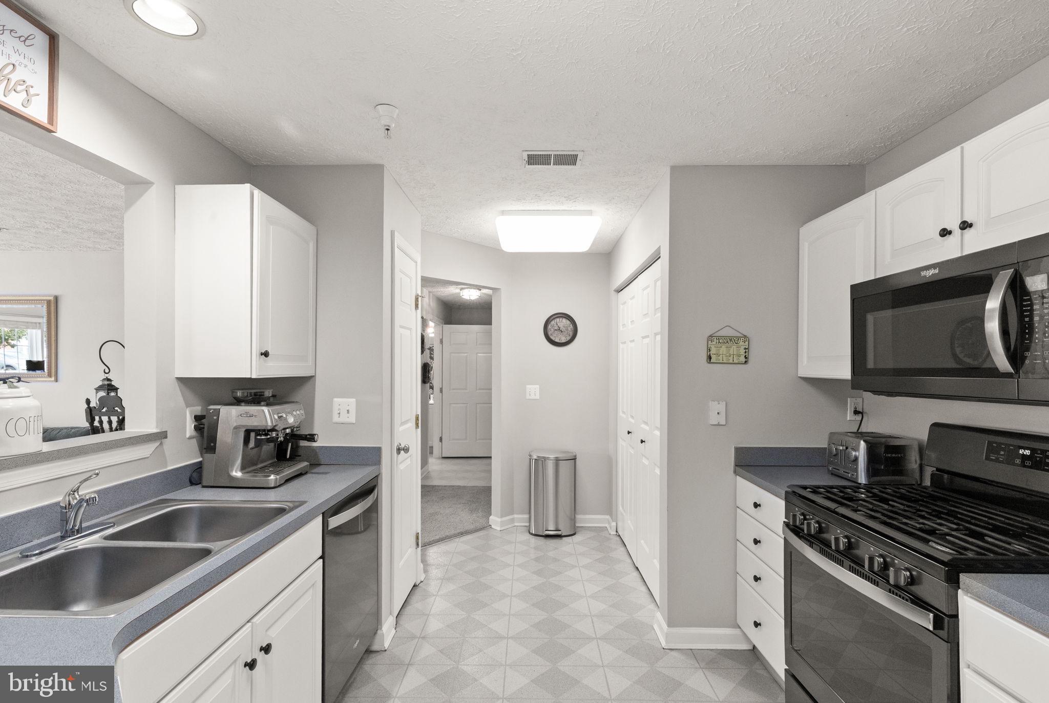 16 Brook Farm Court, Unit 16D Perry Hall, MD 21128 - Photo 4 of 23 a kitchen with stainless steel appliances a sink stove and refrigerator