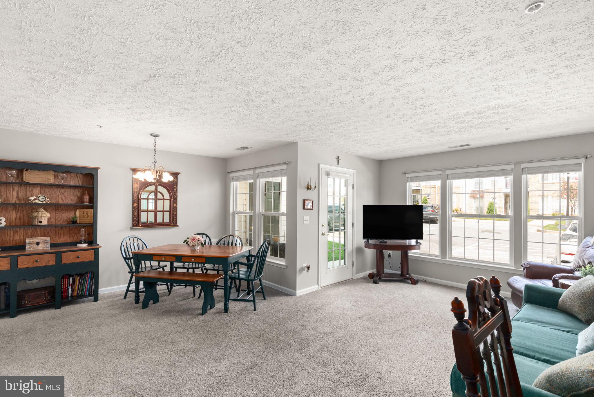 16 Brook Farm Court, Unit 16D Perry Hall, MD 21128 - Photo 6 of 23 a living room with furniture and a flat screen tv