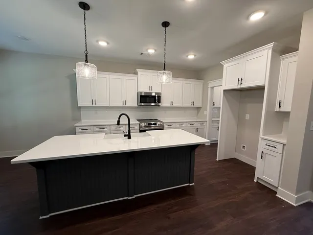 a kitchen with stainless steel appliances sink stove and refrigerator