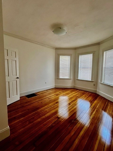 87 Bailey Street, Unit 1 Boston, MA 02124 - Photo 11 of 11 an empty room with wooden floor and windows