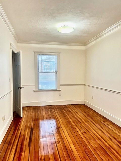 87 Bailey Street, Unit 1 Boston, MA 02124 - Photo 5 of 11 a view of empty room with wooden floor