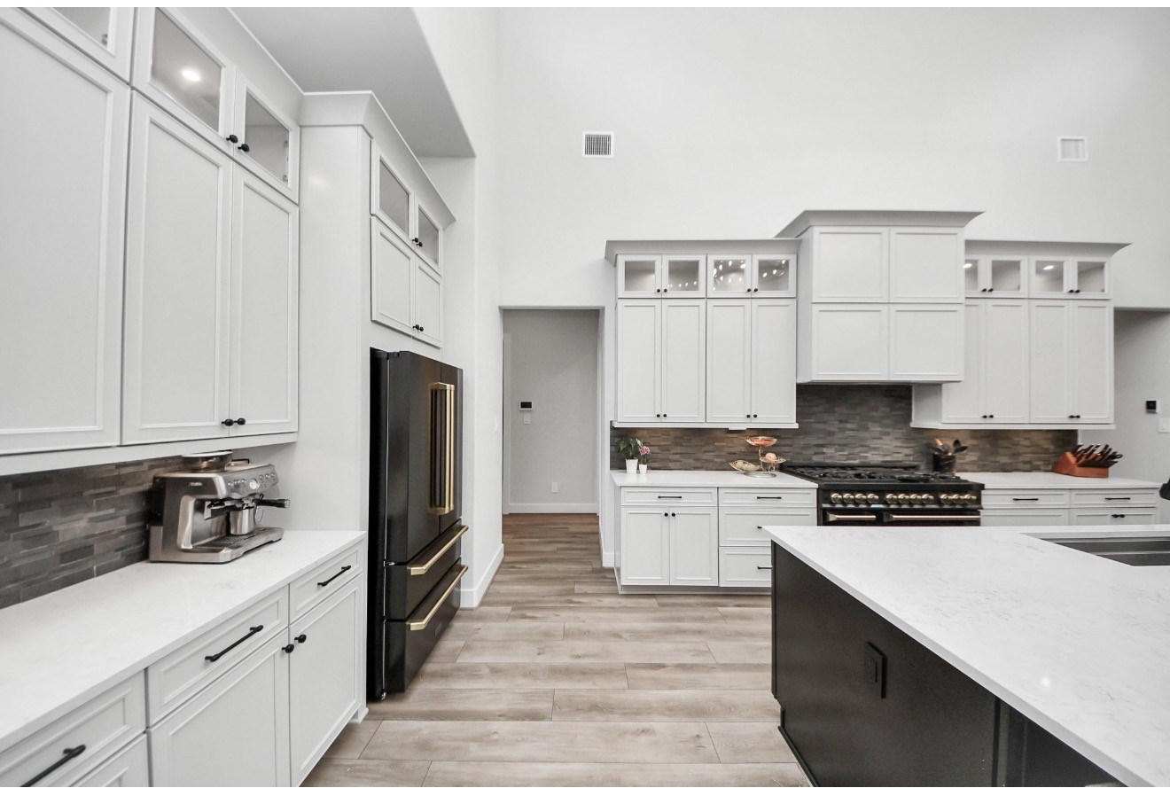 12784 Oak Barrel Road Willis, TX 77378 - Photo 12 of 28 a kitchen with stainless steel appliances a stove refrigerator sink and cabinets