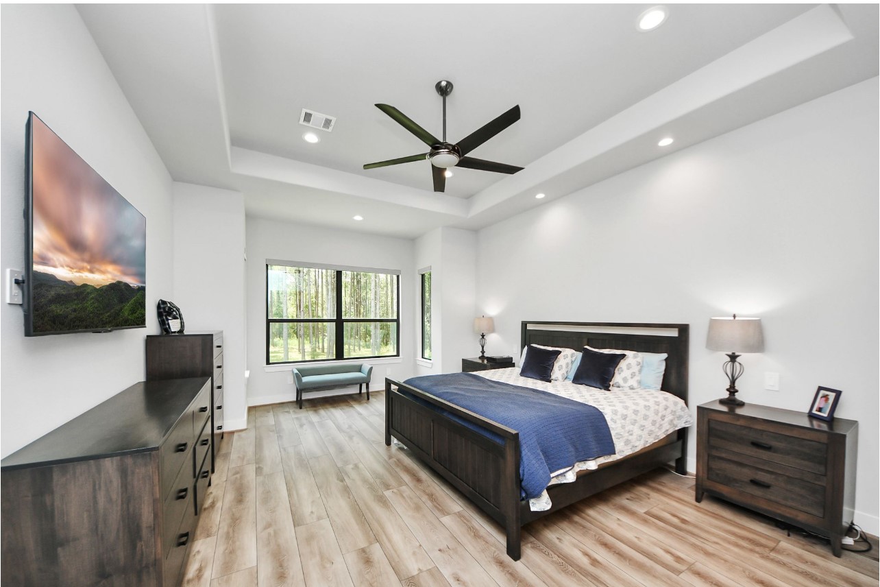 12784 Oak Barrel Road Willis, TX 77378 - Photo 13 of 28 a bedroom with a bed and a large window