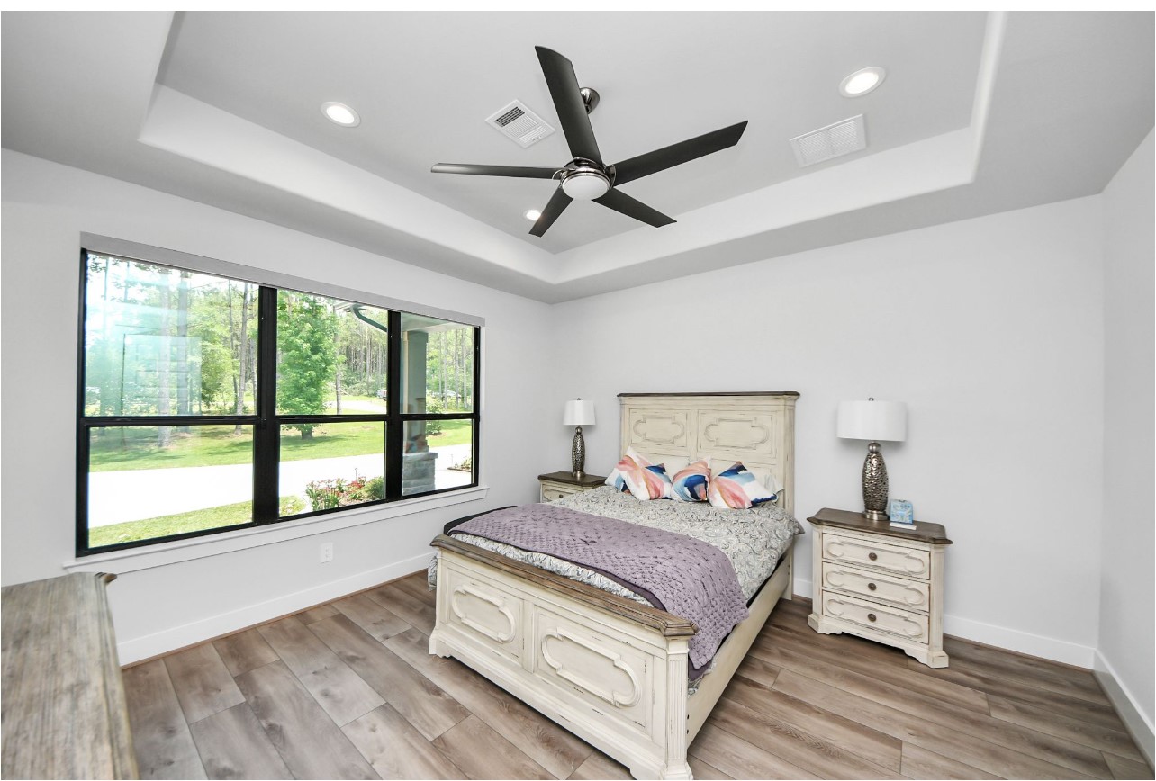 12784 Oak Barrel Road Willis, TX 77378 - Photo 16 of 28 a bedroom with a large bed and a large window