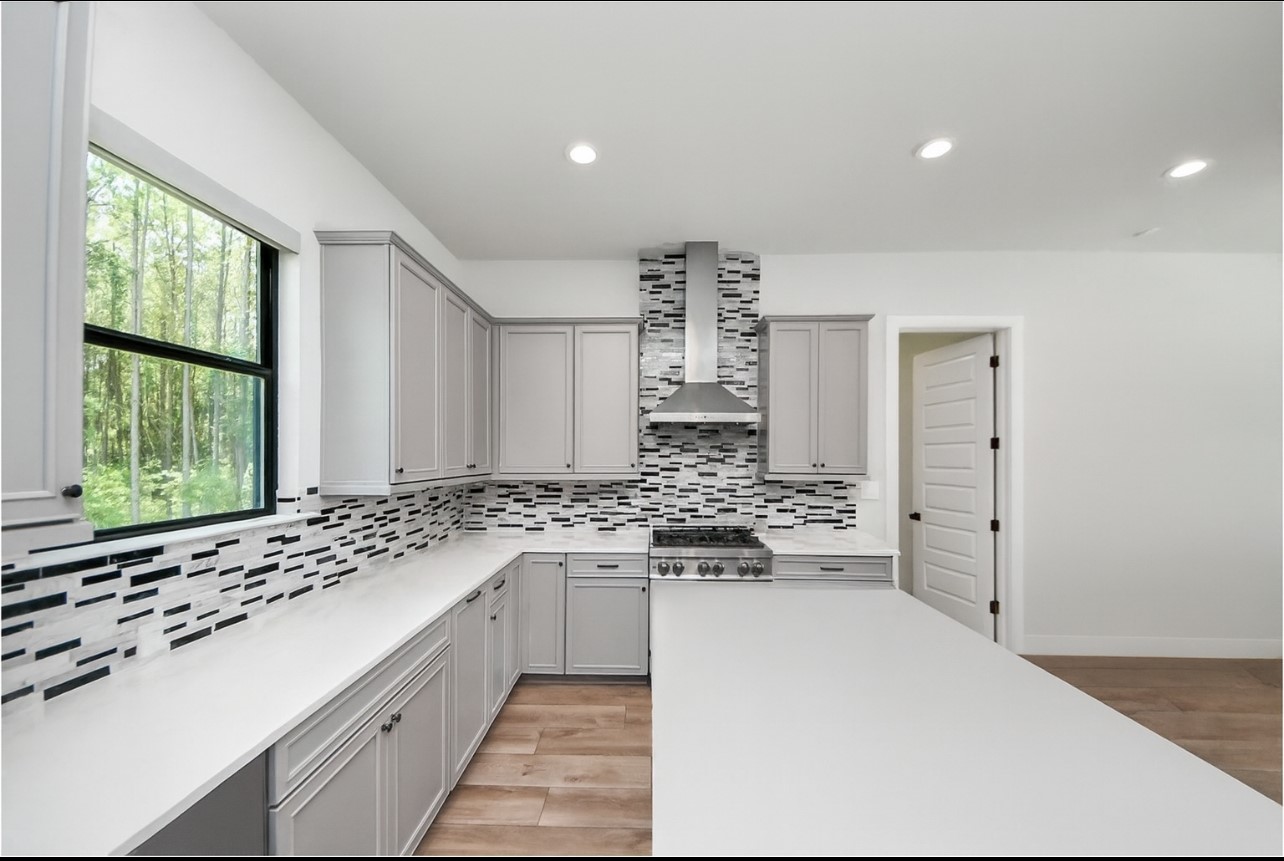 12784 Oak Barrel Road Willis, TX 77378 - Photo 23 of 28 a kitchen with a stove a sink and a refrigerator