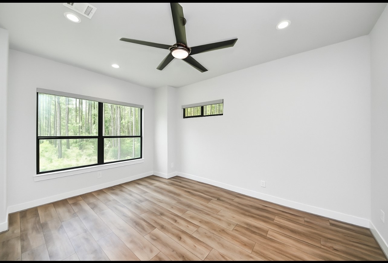 12784 Oak Barrel Road Willis, TX 77378 - Photo 25 of 28 a view of an empty room with a window and wooden floor