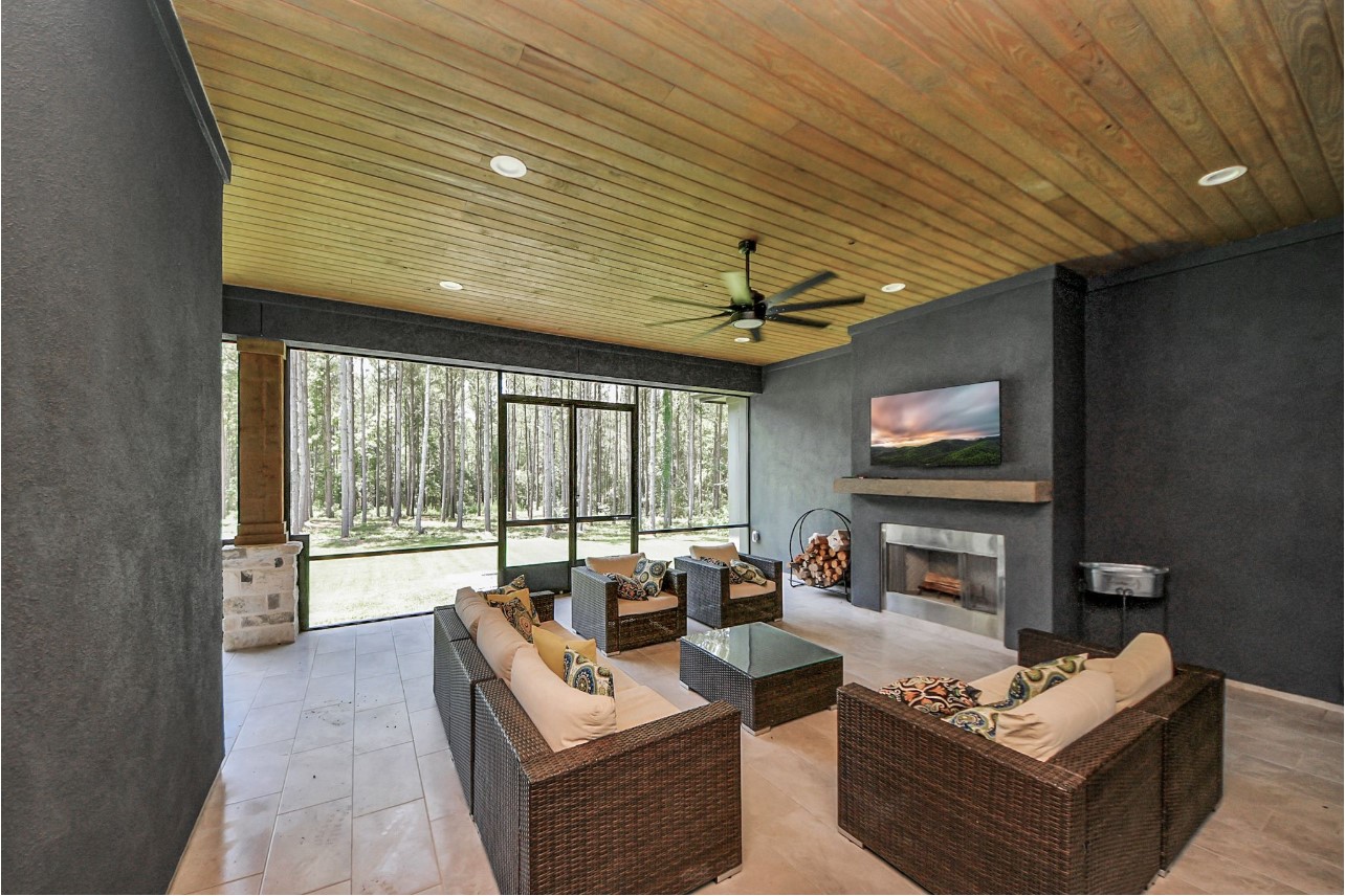 12784 Oak Barrel Road Willis, TX 77378 - Photo 27 of 28 a living room with fireplace furniture and a flat screen tv