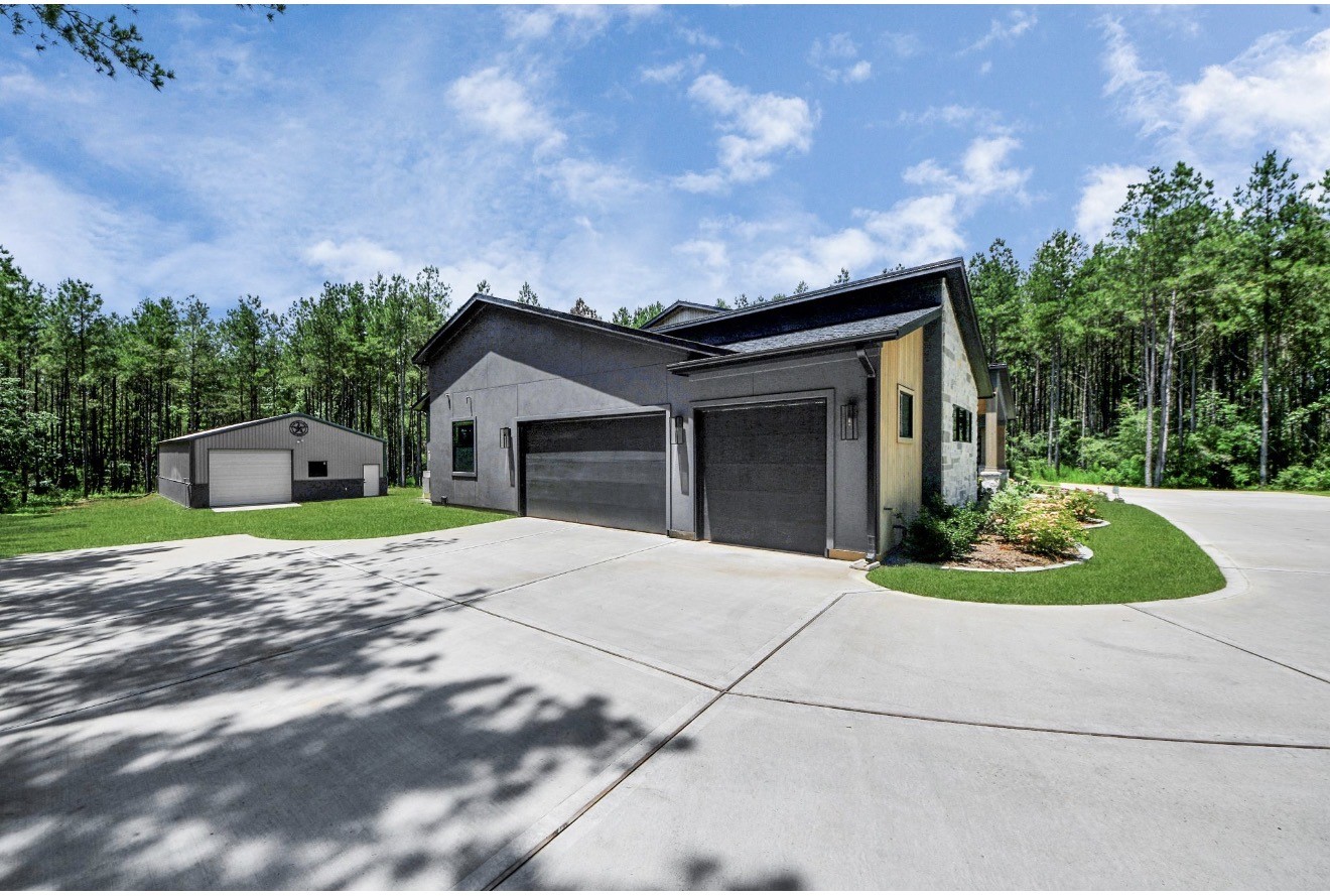 12784 Oak Barrel Road Willis, TX 77378 - Photo 3 of 28 a front view of a house with a garden and yard