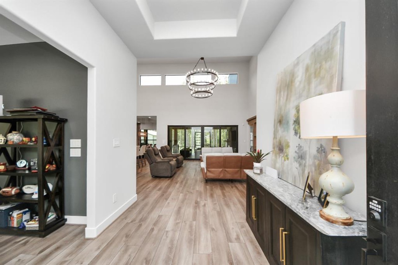 12784 Oak Barrel Road Willis, TX 77378 - Photo 8 of 28 a living room with furniture and a chandelier