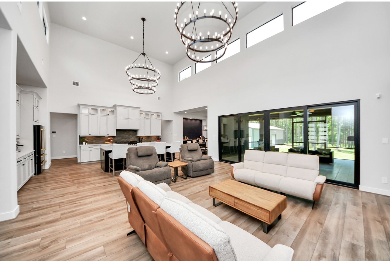 12784 Oak Barrel Road Willis, TX 77378 - Photo 10 of 28 a living room with furniture chandelier and large windows