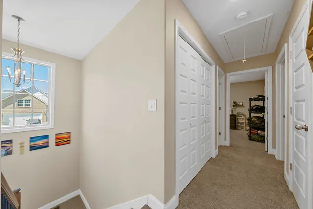 a spacious bedroom with a bed and a chandelier