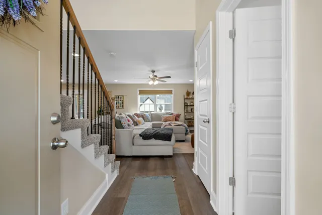 a living room with furniture a window and a ceiling fan
