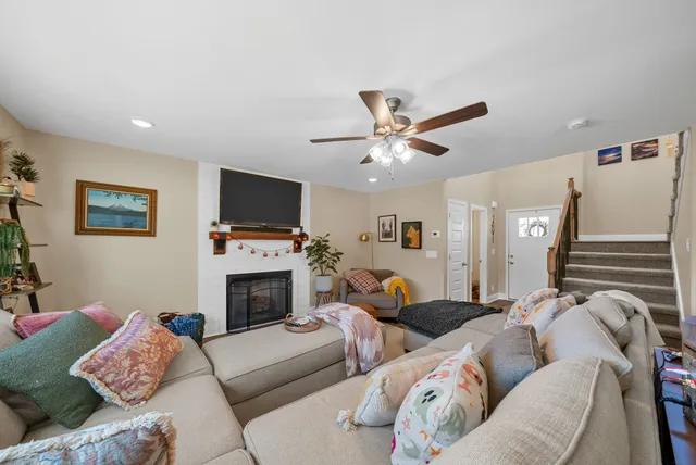 a living room with furniture a flat screen tv and a fireplace