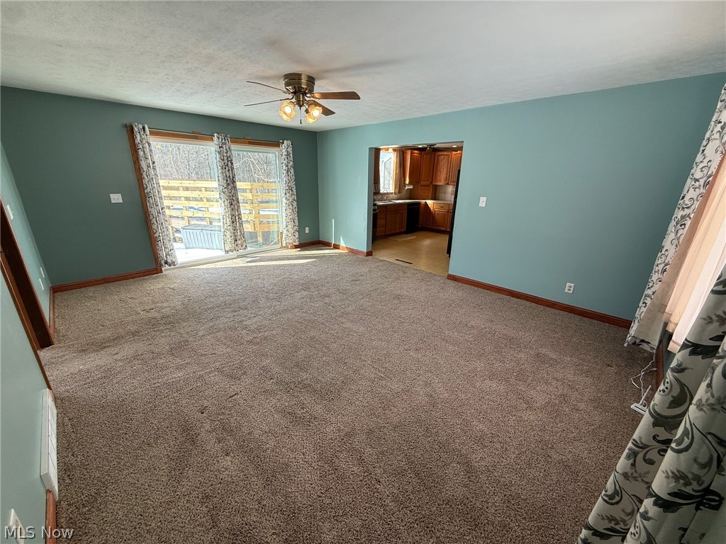 6784 Old Zoarville Road Northeast Dover, OH 44622 - Photo 18 of 50 Unfurnished bedroom with light carpet, a textured ceiling, ensuite bathroom, a ceiling fan, and access to outside
