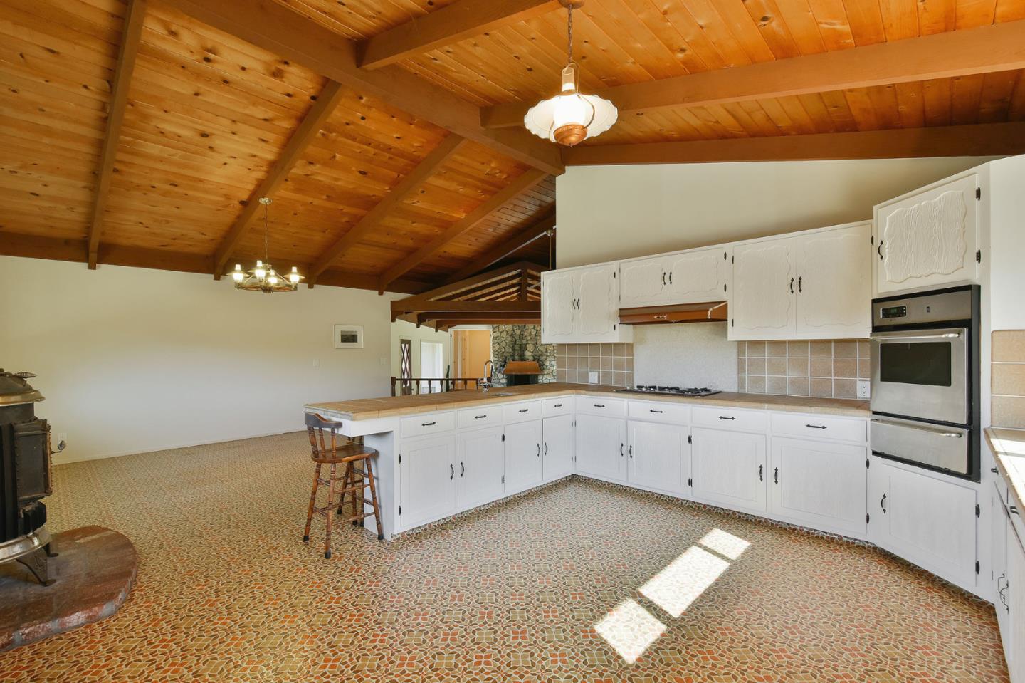 991 Zamora Drive Pacifica, CA 94044 - Photo 19 of 26 a kitchen with cabinets and window