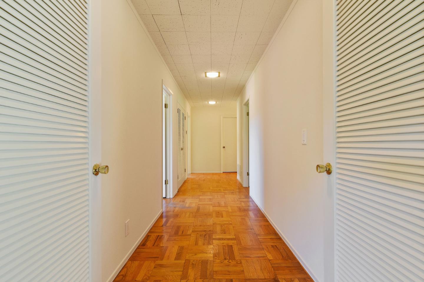 991 Zamora Drive Pacifica, CA 94044 - Photo 21 of 26 a view of a hallway with wooden floor