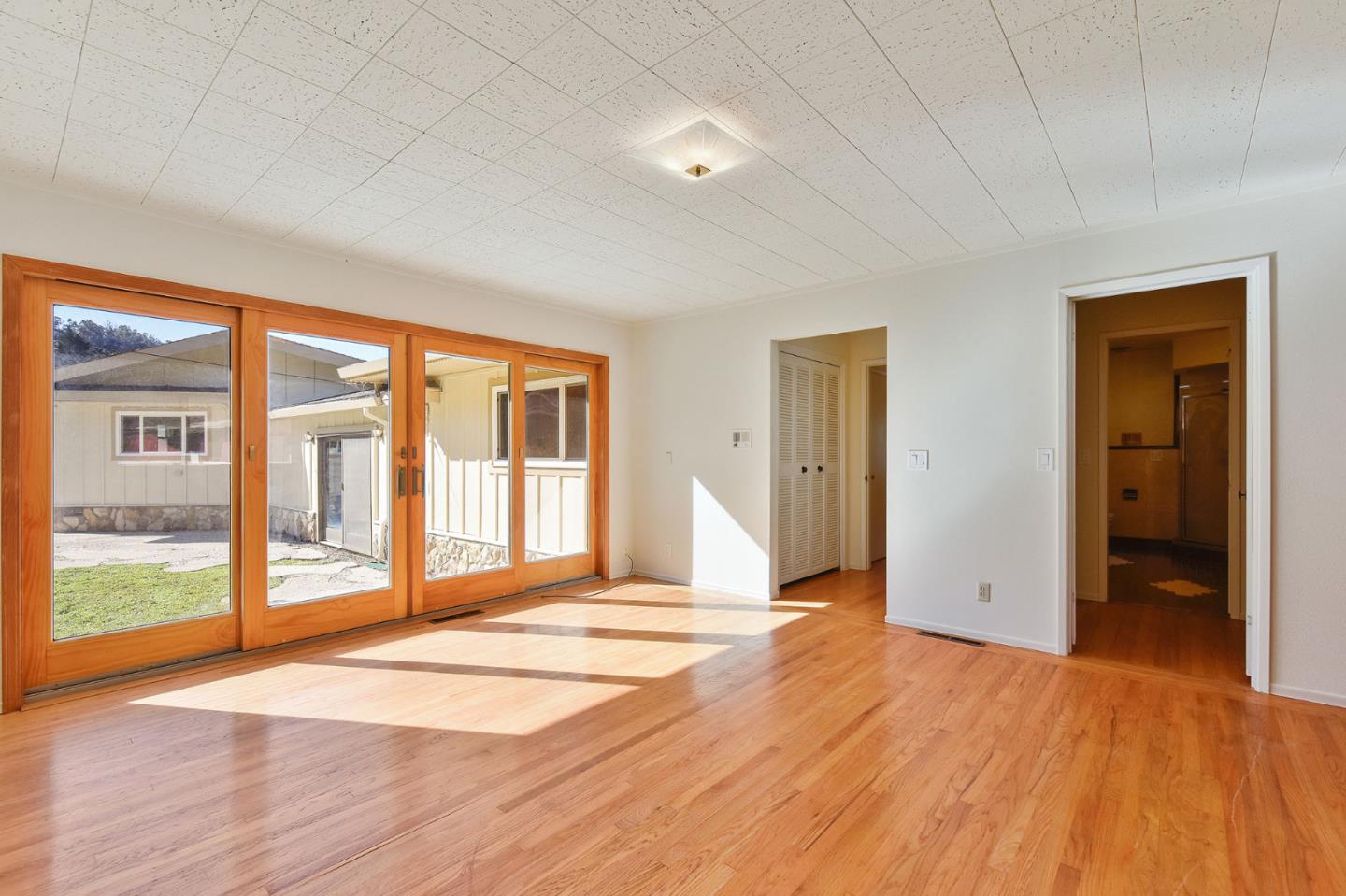991 Zamora Drive Pacifica, CA 94044 - Photo 22 of 26 a view of empty room with wooden floor and fan