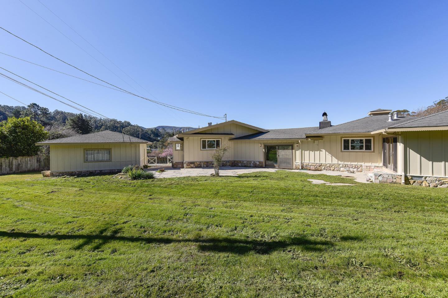 991 Zamora Drive Pacifica, CA 94044 - Photo 7 of 26 a front view of a house with a garden