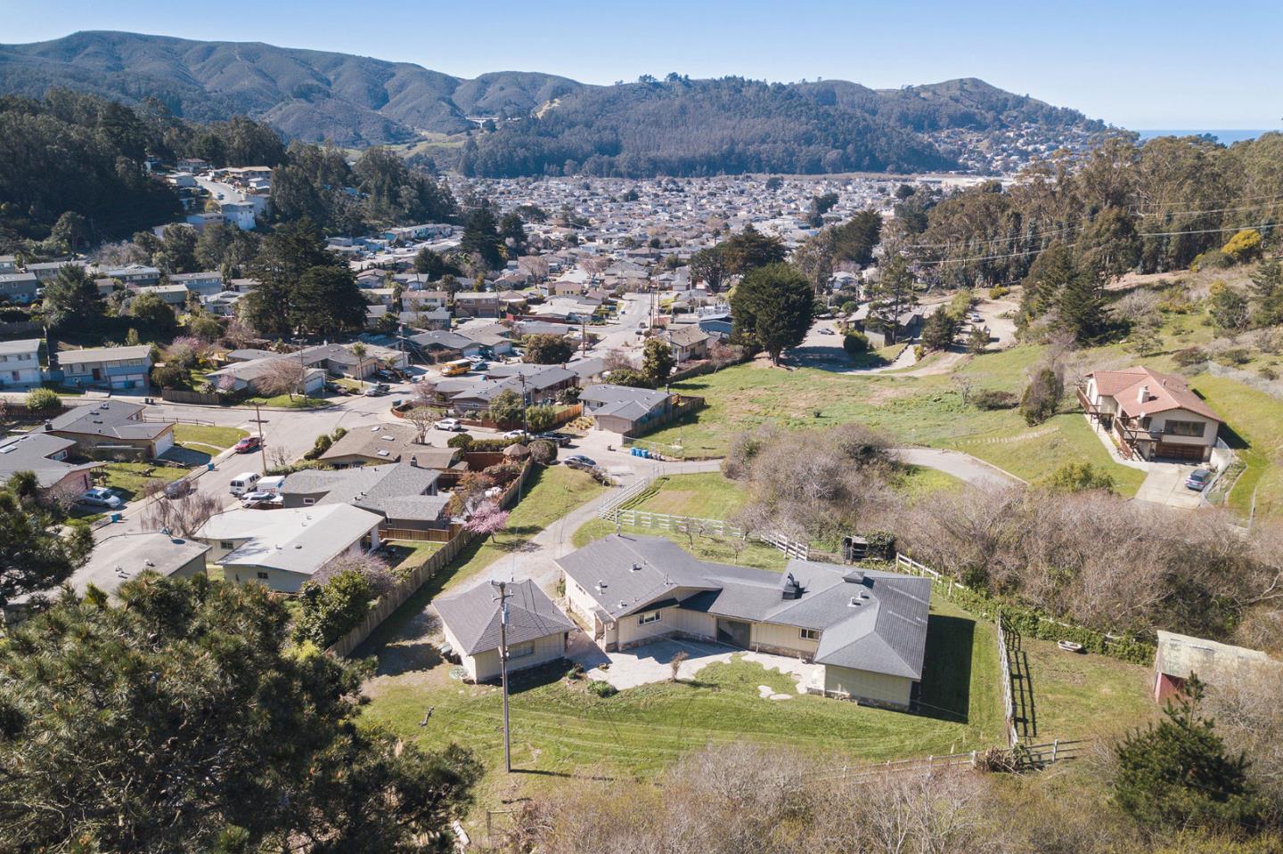 991 Zamora Drive Pacifica, CA 94044 - Photo 9 of 26 a view of a city with mountains