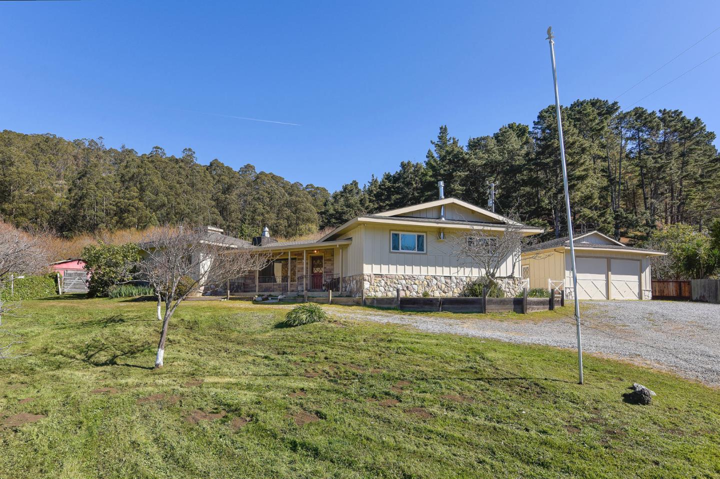 991 Zamora Drive Pacifica, CA 94044 - Photo 10 of 26 a front view of a house with a yard