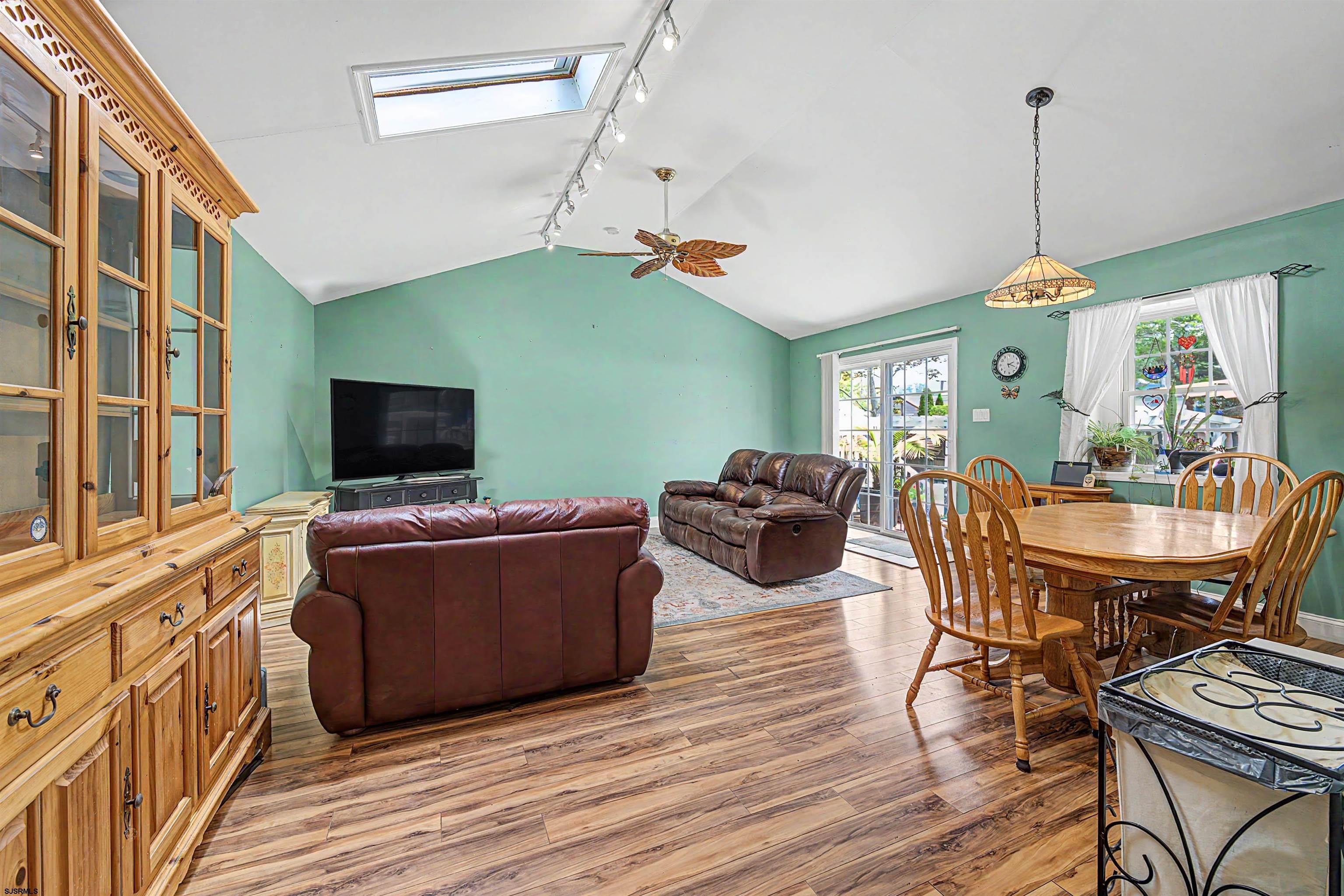 125 Exton Road Somers Point, NJ 08244 - Photo 14 of 35 a living room with furniture a flat screen tv and kitchen view