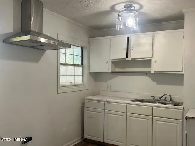 a kitchen with a sink and cabinets