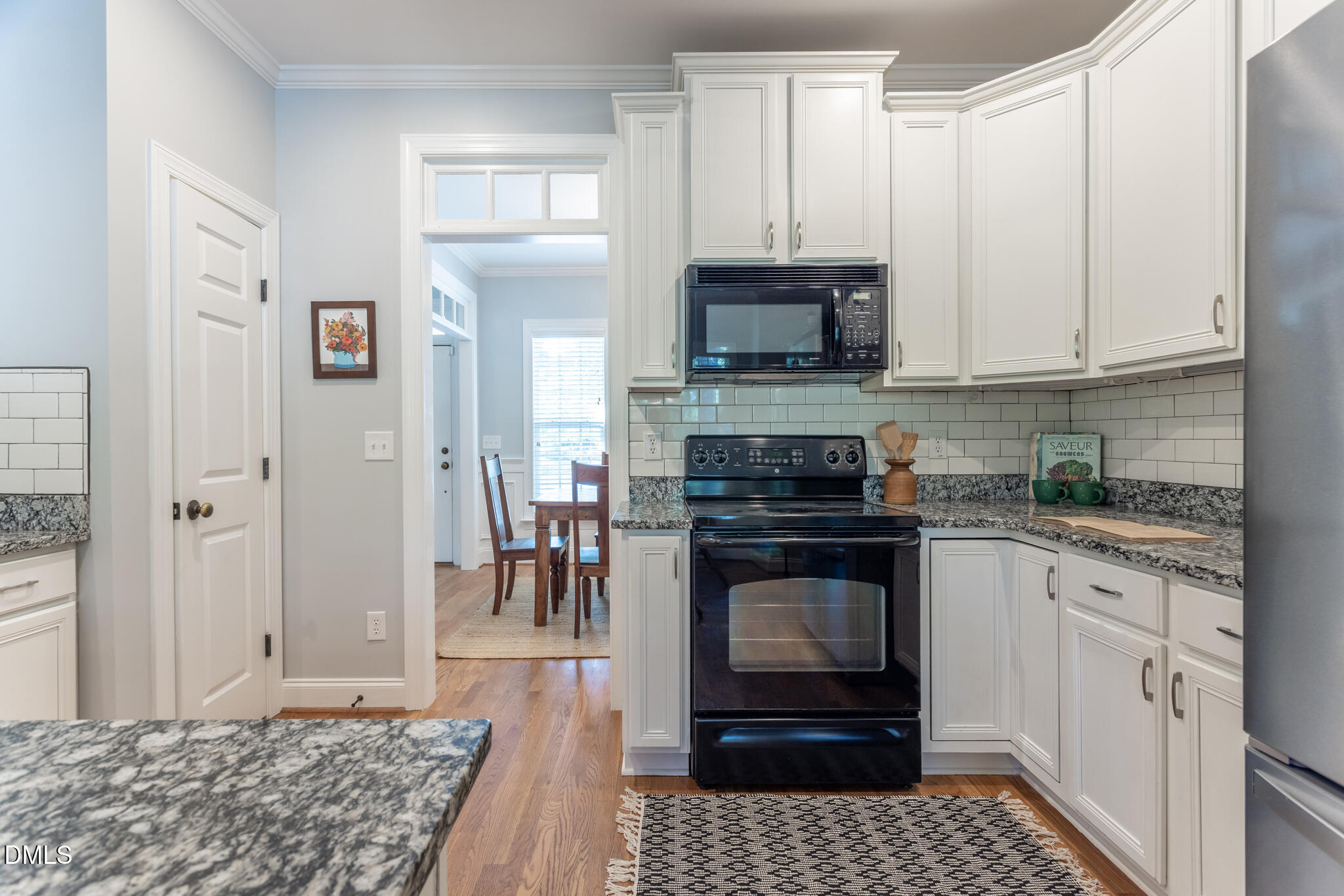 10 Highgrove Lane Durham, NC 27713 - Photo 12 of 41 a kitchen with stainless steel appliances granite countertop a stove a sink and a microwave