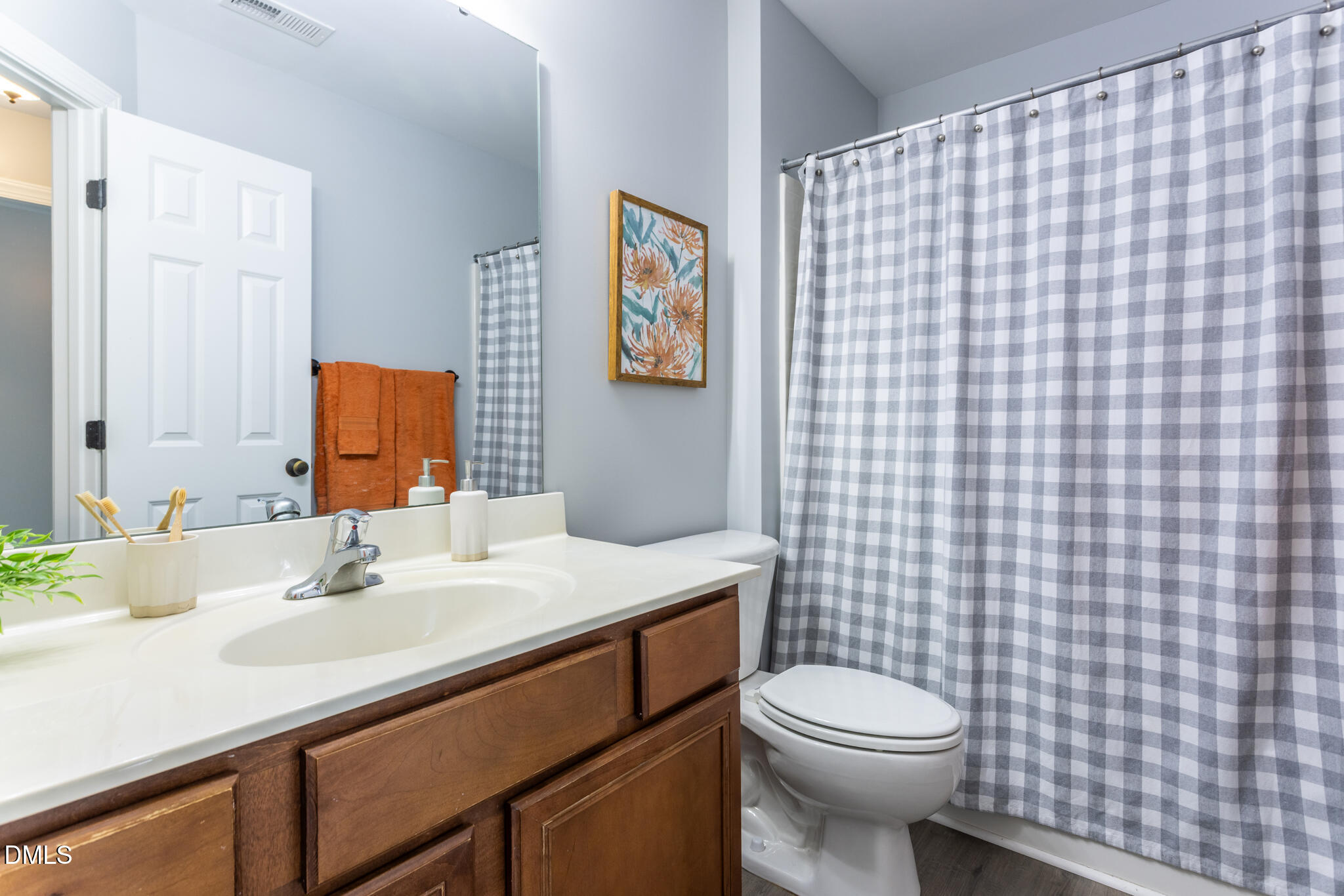10 Highgrove Lane Durham, NC 27713 - Photo 19 of 41 a bathroom with a sink a toilet and mirror