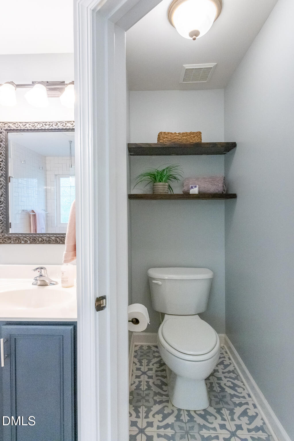 10 Highgrove Lane Durham, NC 27713 - Photo 24 of 41 a bathroom with a toilet a sink and mirror