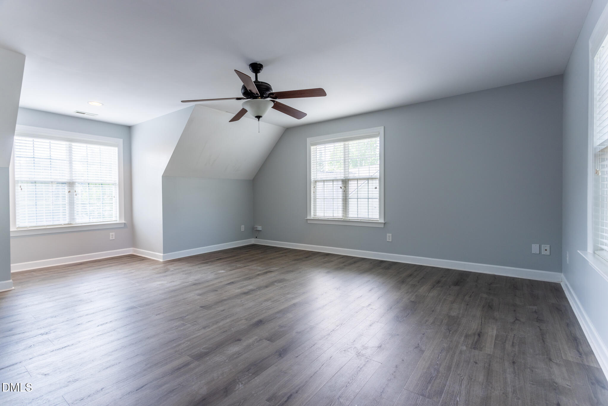10 Highgrove Lane Durham, NC 27713 - Photo 29 of 41 an empty room with wooden floor ceiling fan and windows