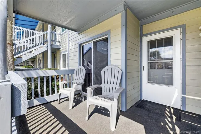 a view of a balcony with furniture