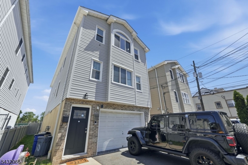 130 3rd Street, Unit 2 Passaic, NJ 07055 - Photo 10 of 12 a front view of a house with parking space