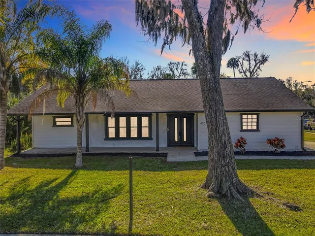 a view of a house with swimming pool and a yard