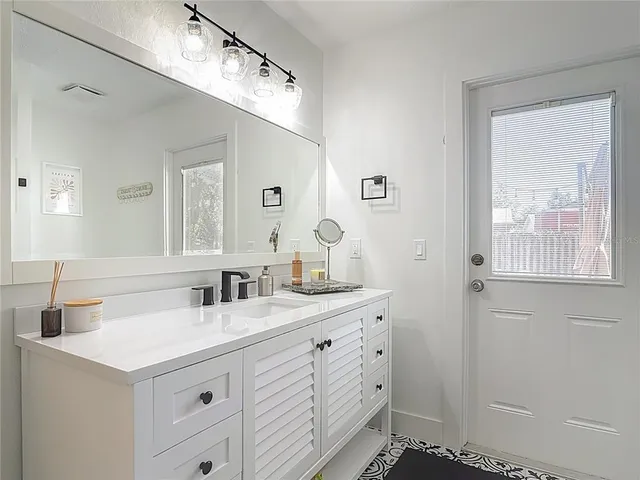 a bathroom with a sink and a mirror