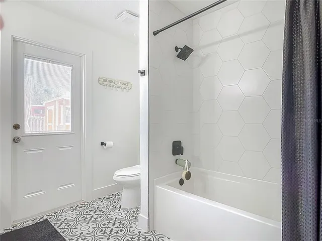 a bathroom with a bathtub a toilet and a shower