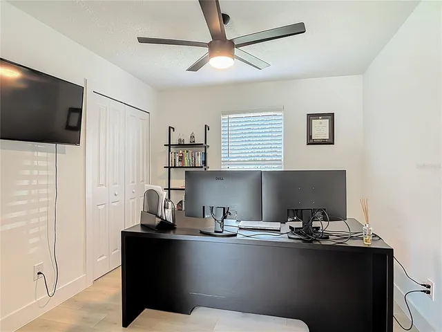 a room with a table chairs and projector