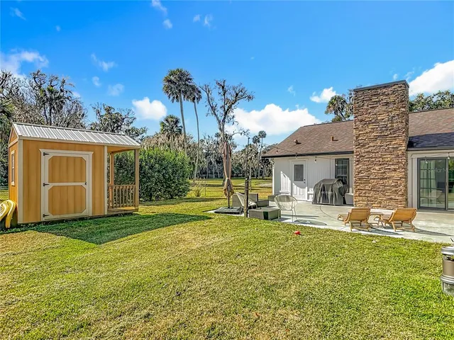 a view of a house with a yard and sitting area