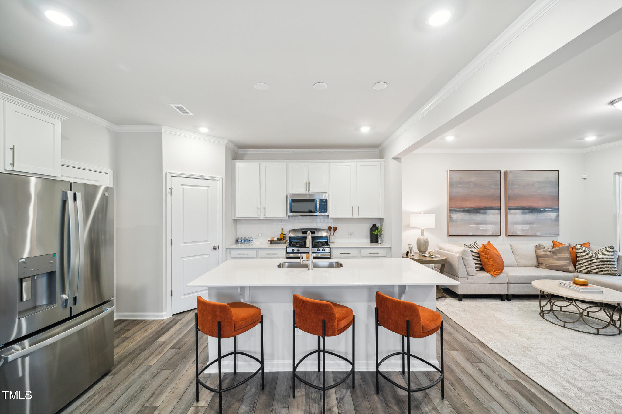 720 Maple Br Circle Graham, NC 27253 - Photo 12 of 40 a kitchen with stainless steel appliances granite countertop a stove a refrigerator a table and chairs