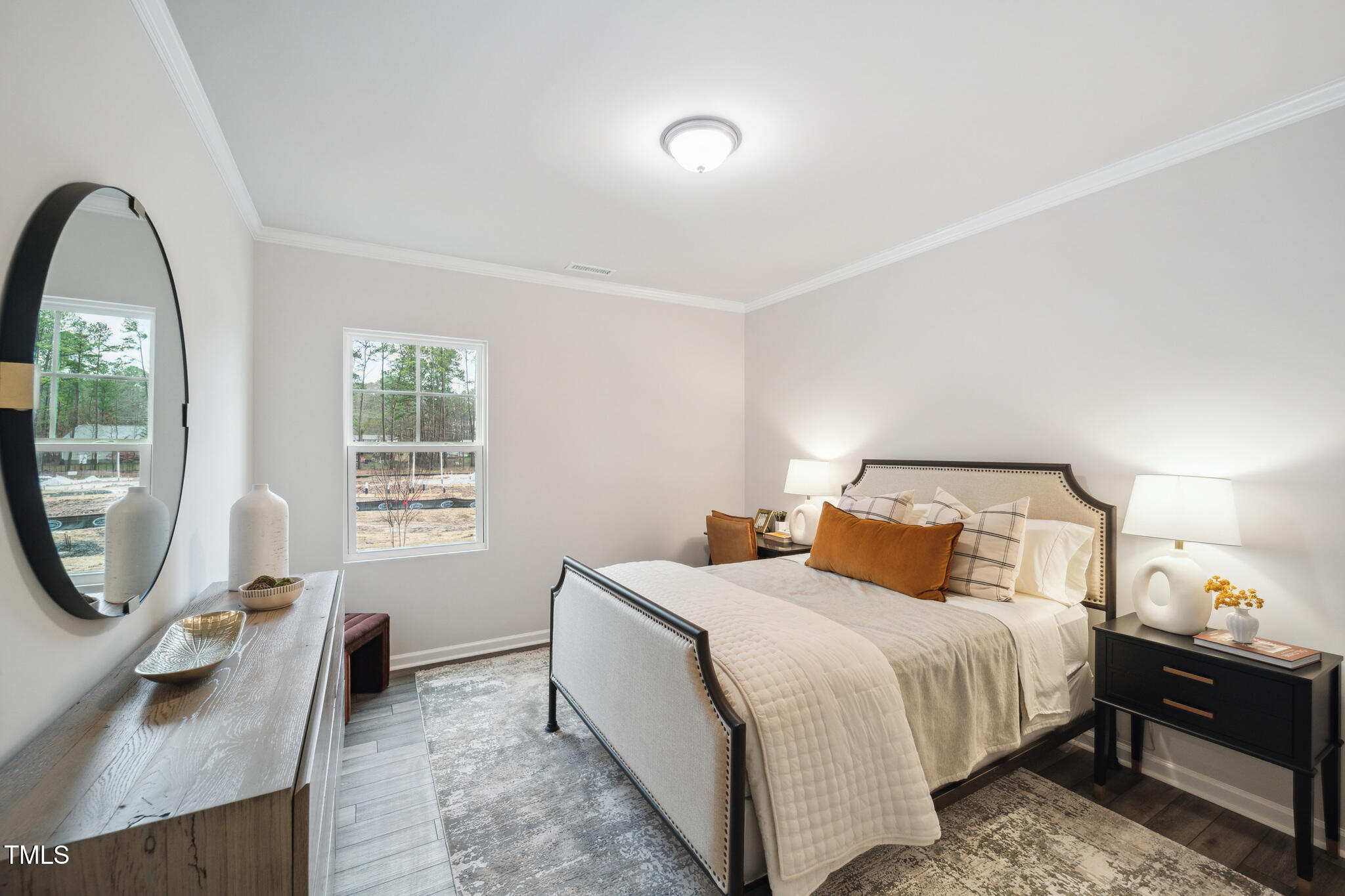 720 Maple Br Circle Graham, NC 27253 - Photo 16 of 40 a bedroom with a bed a mirror and a window