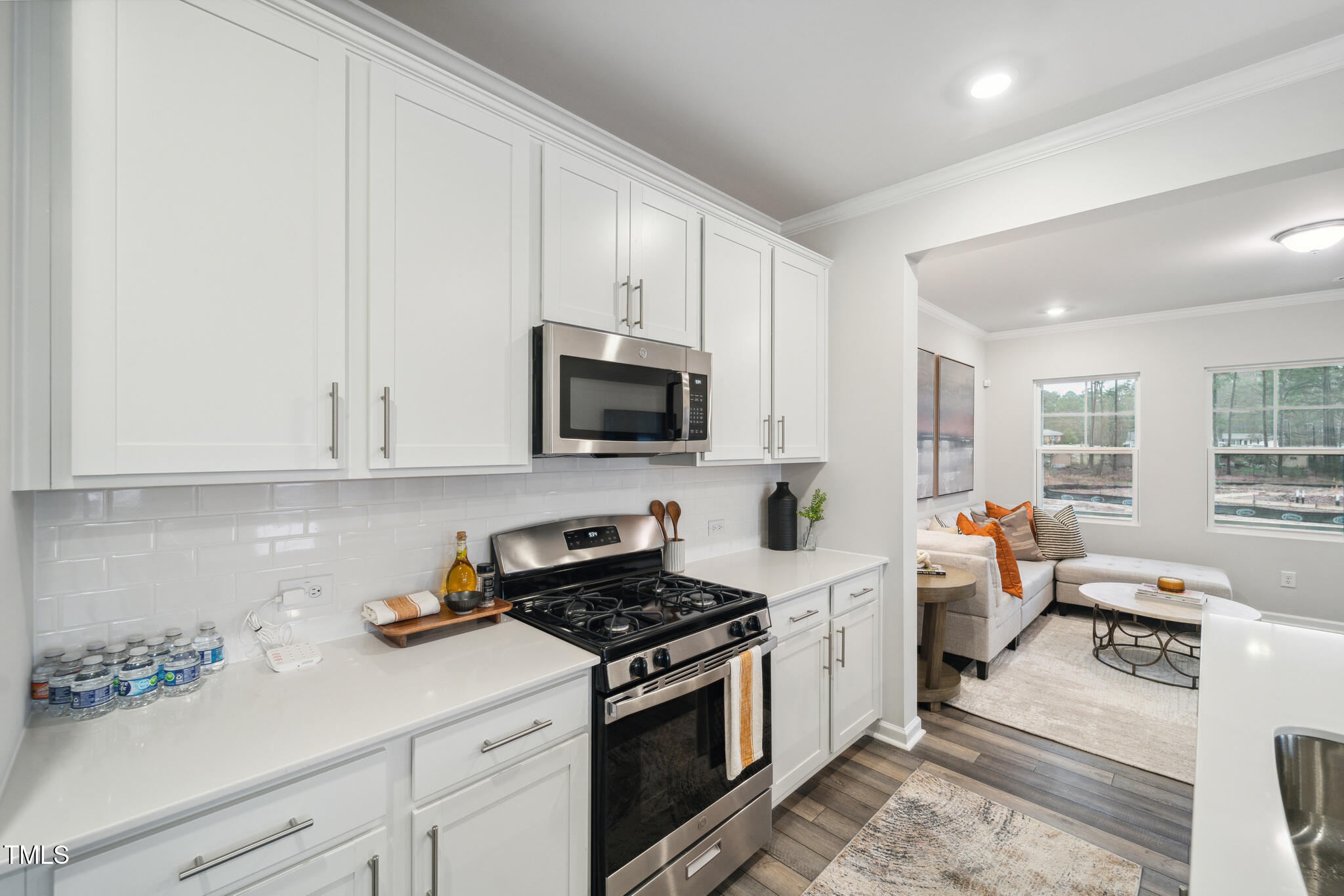 720 Maple Br Circle Graham, NC 27253 - Photo 25 of 40 a kitchen with stainless steel appliances a white stove top oven and white cabinets