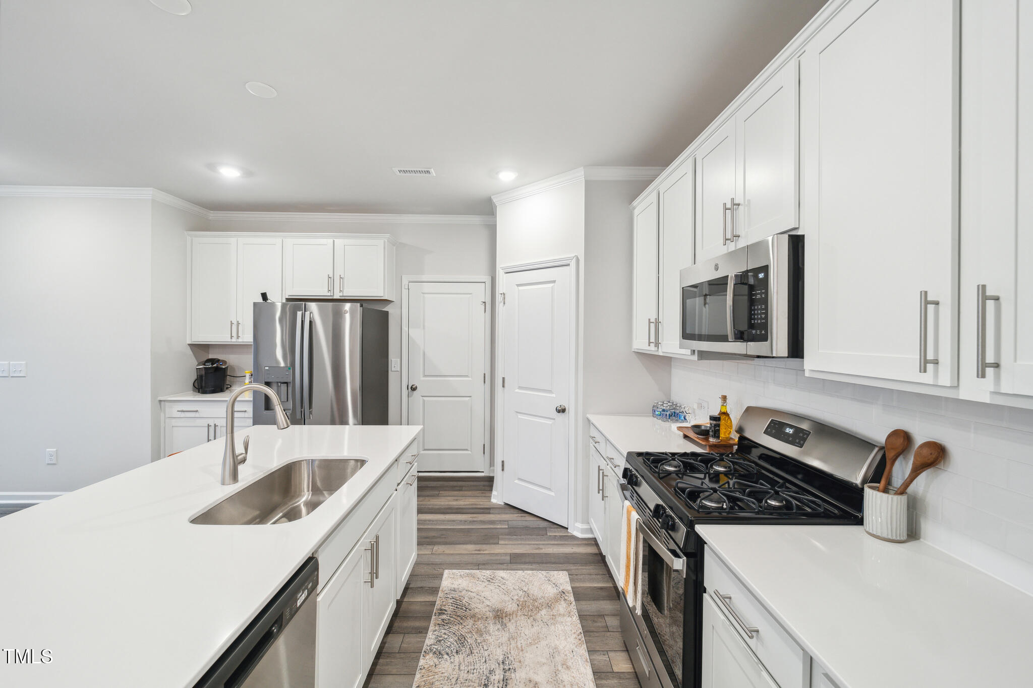 720 Maple Br Circle Graham, NC 27253 - Photo 10 of 40 a kitchen with stainless steel appliances granite countertop a sink stove and refrigerator