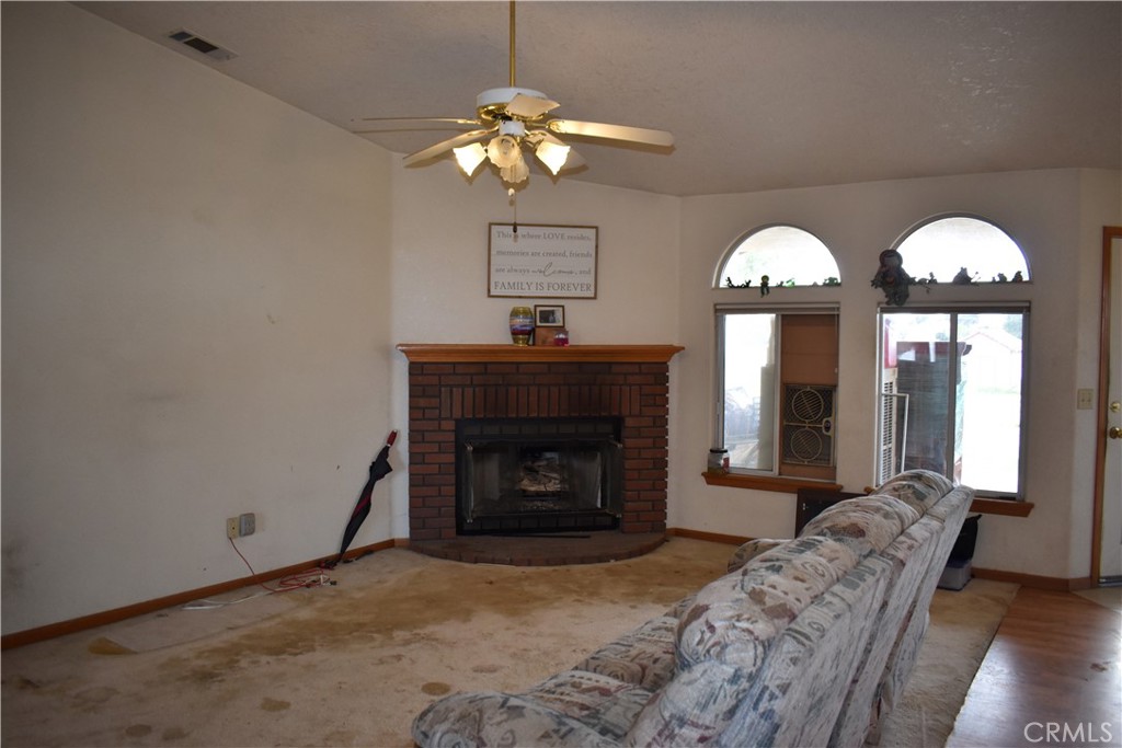 19485 Kinai Road Apple Valley, CA 92307 - Photo 8 of 12 a living room with furniture chandelier and a fireplace