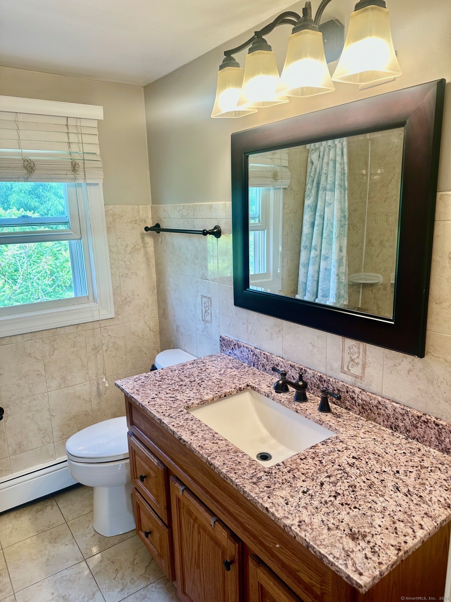 254 Sand Hill Road South Windsor, CT 06074 - Photo 10 of 20 a bathroom with a granite countertop sink a toilet and a mirror