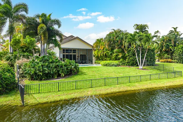 a view of a house with a big yard and potted plants