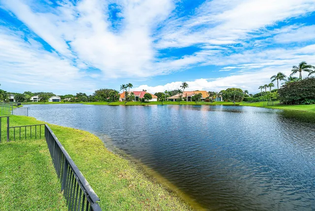 a view of a lake with houses in the back