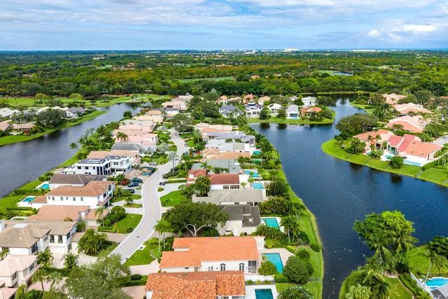 an aerial view of residential houses with outdoor space and river