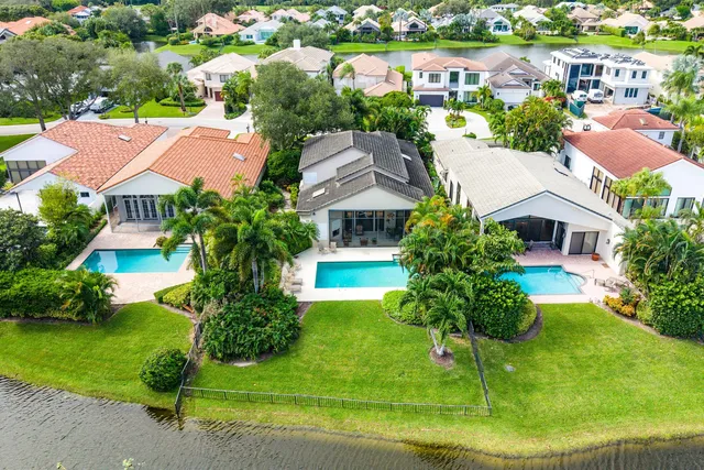 an aerial view of multiple houses with yard
